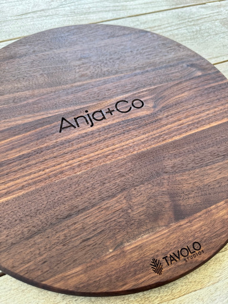 Walnut cutting board engraved with "Anja+Co" — example of a realtor closing gift from Tavolo Studios.