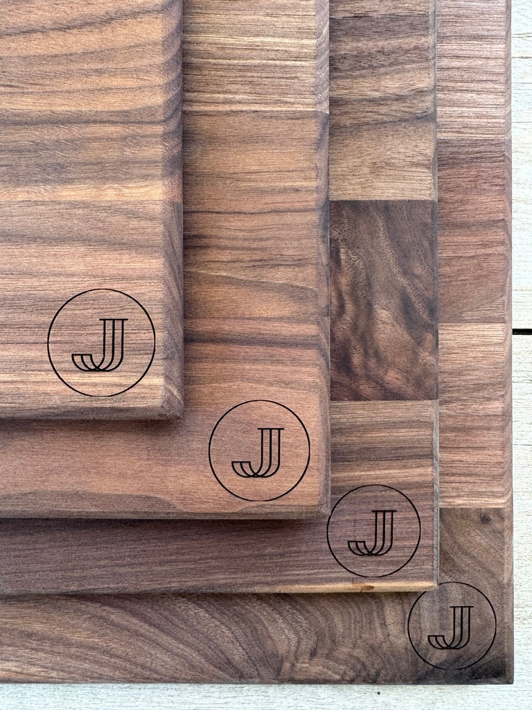 Multiple engraved walnut boards arranged together — bulk pricing example.