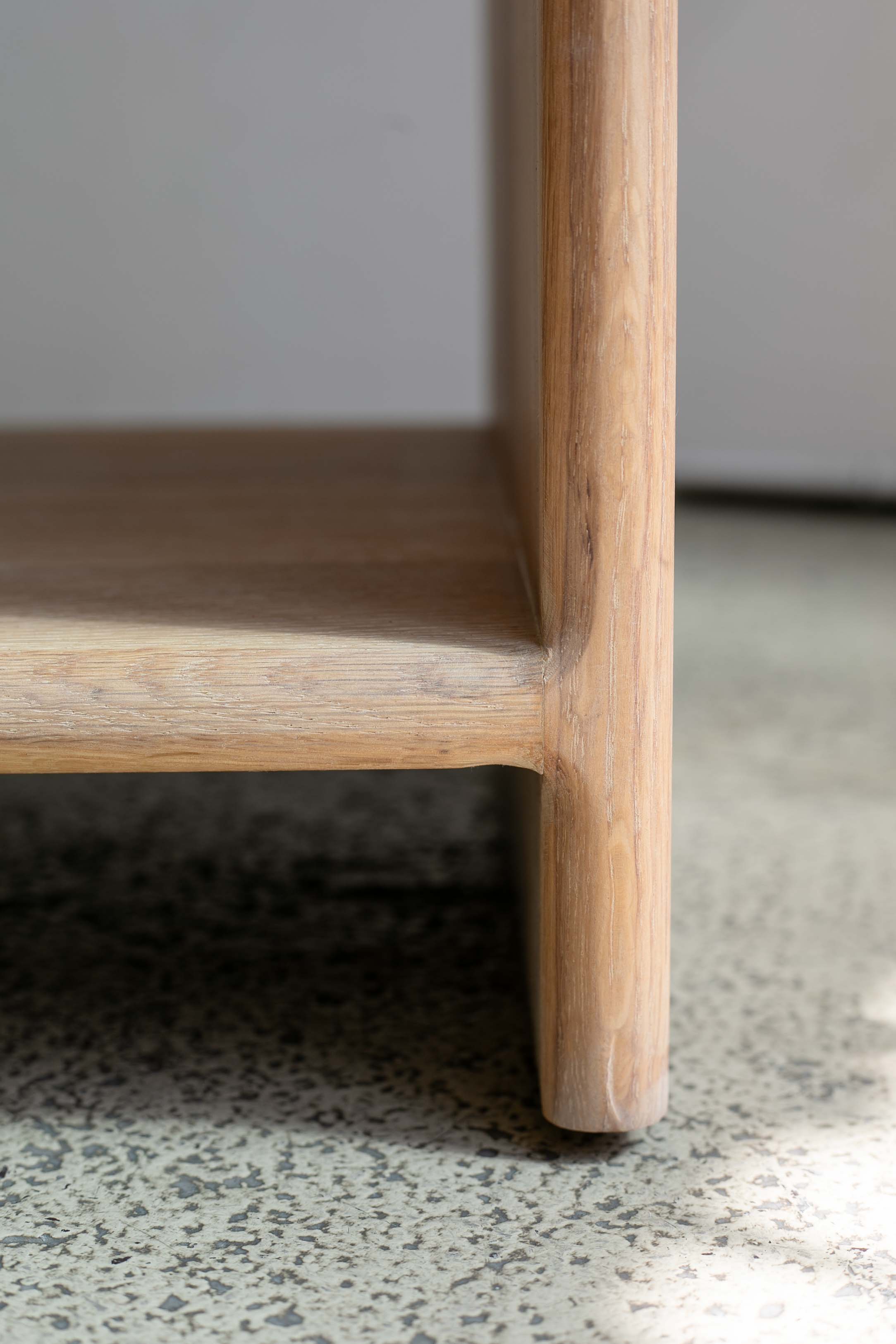 Detail of the leg and base on a handcrafted solid white oak nightstand by Tavolo Studios.